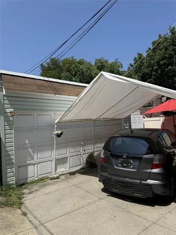 a view of a car parked front of a house