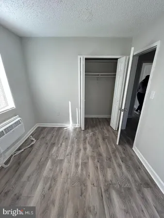 an empty room with wooden floor and closet