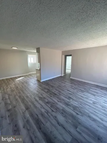 a view of an empty room and wooden floor