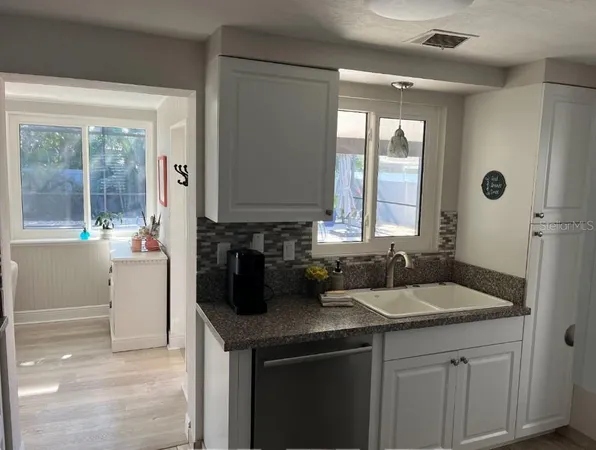 a kitchen with a sink and cabinets