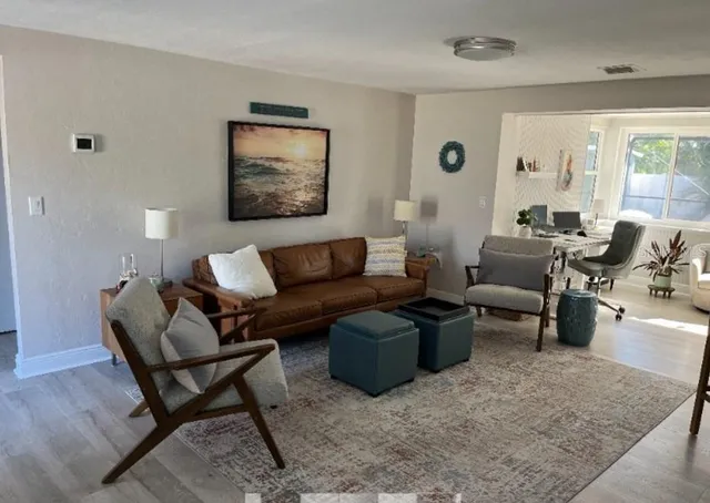 a living room with furniture and a large window