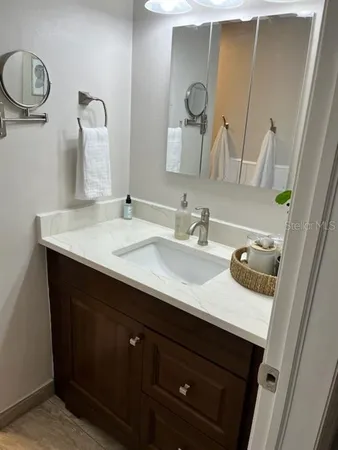 a bathroom with a sink and a mirror