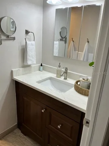 a bathroom with a sink and a mirror