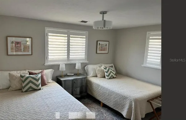 a bedroom with bed and window