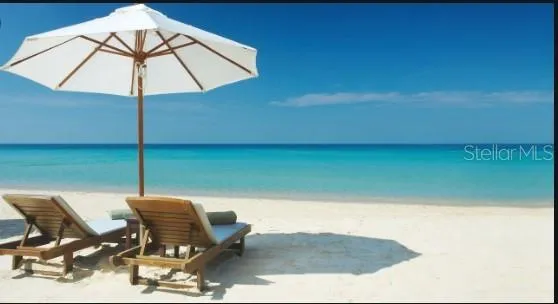 a view of a terrace with chairs and an umbrella
