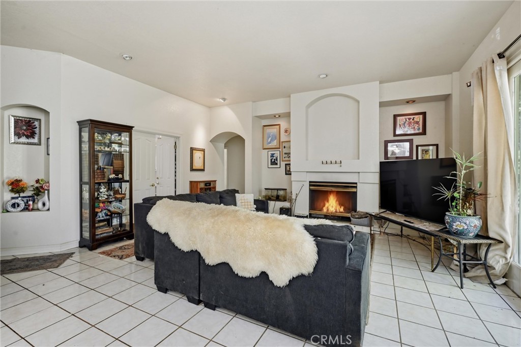 19552 Powder Horn Road Hidden Valley Lake, CA 95467 - Photo 11 of 30 a living room with furniture a flat screen tv and a fireplace