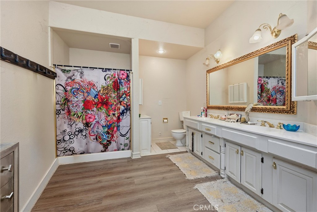 19552 Powder Horn Road Hidden Valley Lake, CA 95467 - Photo 17 of 30 a bathroom with a double vanity sink mirror and double