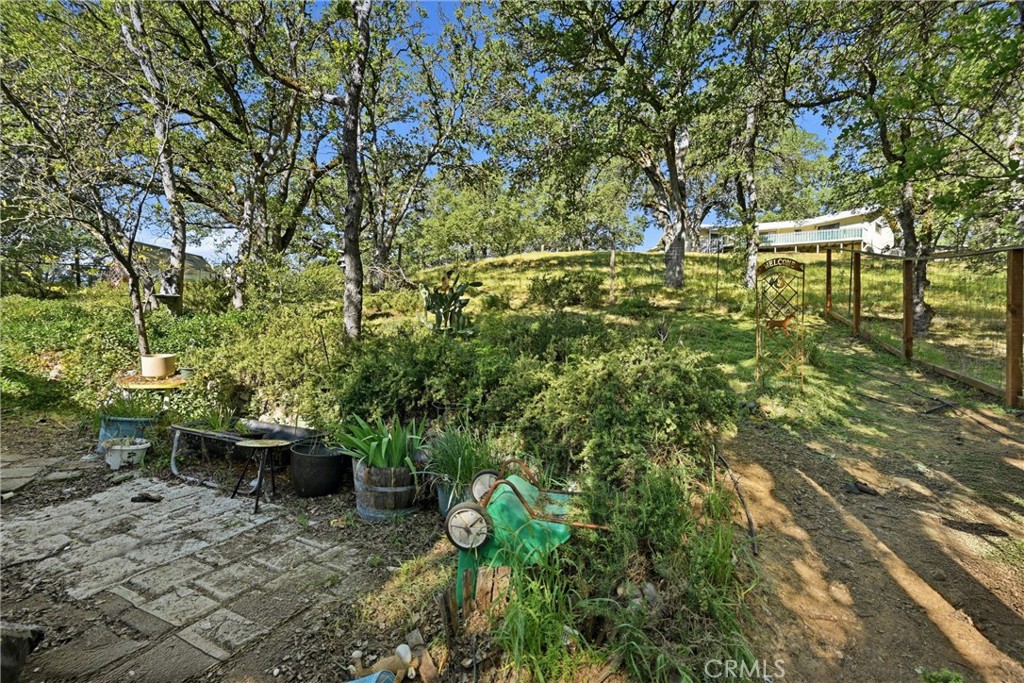 19552 Powder Horn Road Hidden Valley Lake, CA 95467 - Photo 26 of 30 a backyard of a house with table and chairs