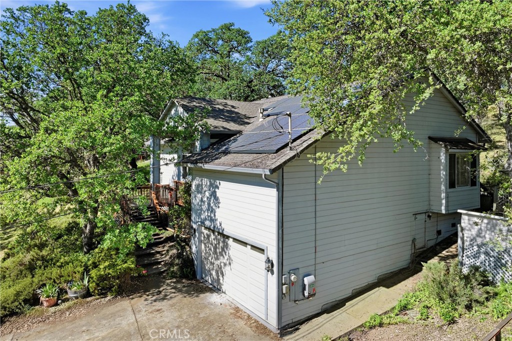 19552 Powder Horn Road Hidden Valley Lake, CA 95467 - Photo 4 of 30 a view of a small yard in front of a house with large tree and wooden fence