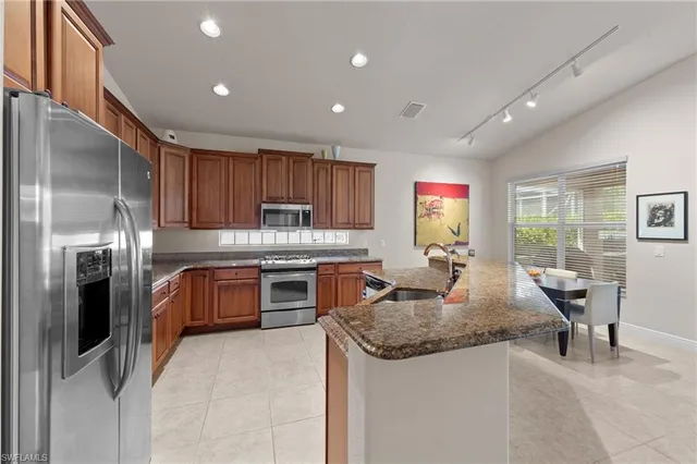 a bathroom with a granite countertop sink a mirror and a shower