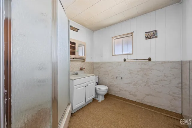 a bathroom with a toilet a sink and a window