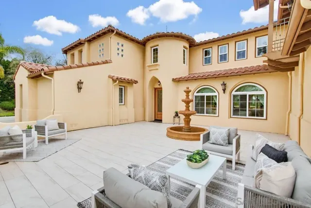 a living room with furniture a window and a chandelier