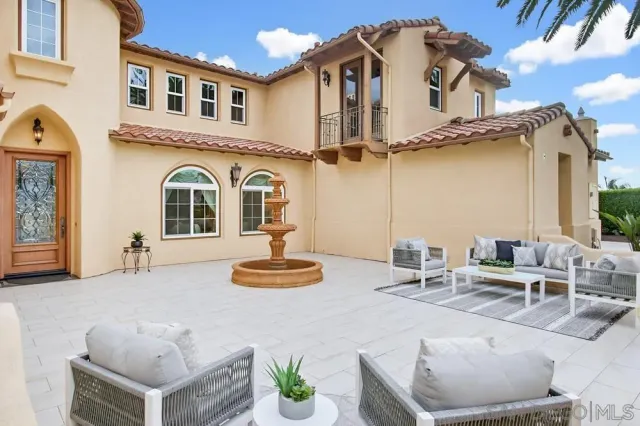 a kitchen with a dining table chairs stove and white cabinets