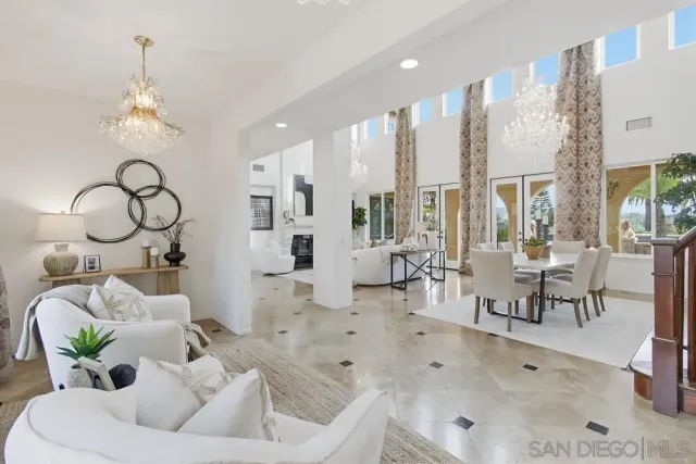 a living room with furniture a window and a chandelier