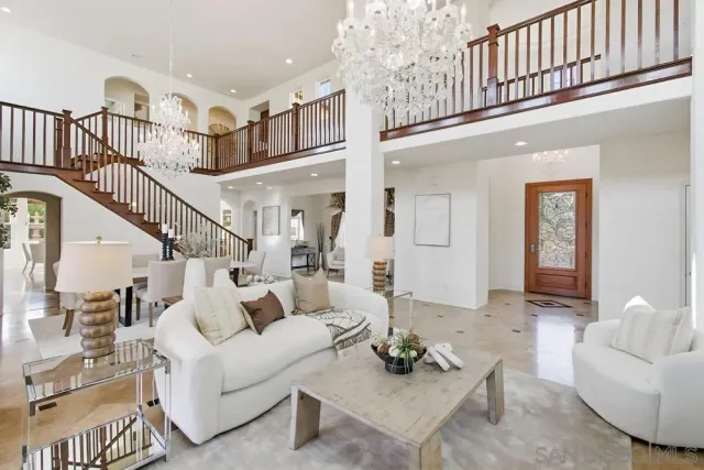 a kitchen with a dining table chairs stove and white cabinets