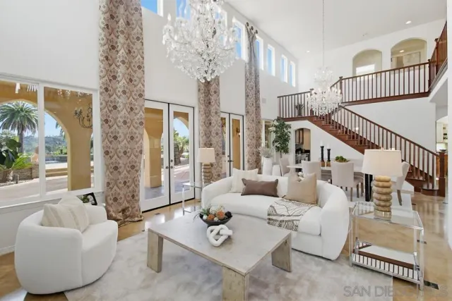 a living room with furniture and a chandelier