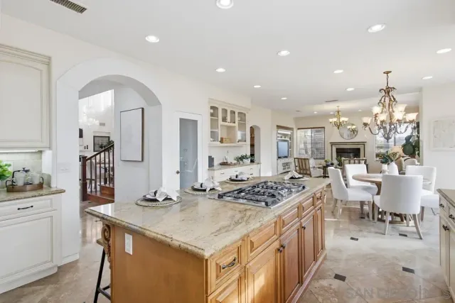 a kitchen with stainless steel appliances granite countertop a sink a stove and cabinets