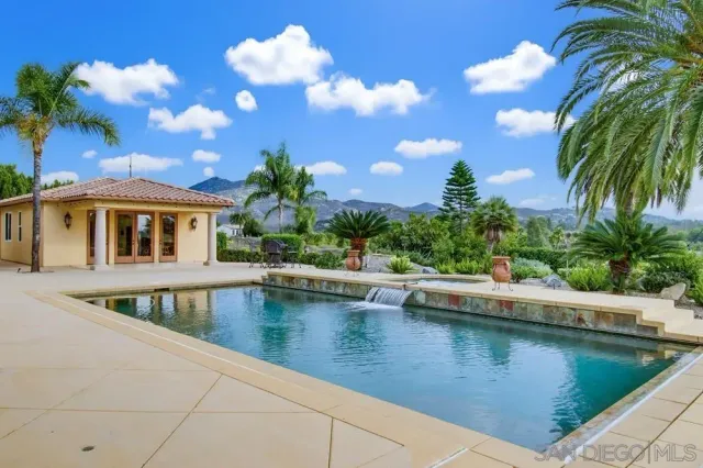 a view of a house with backyard and sitting area