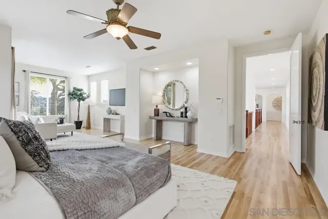 a spacious bedroom with a bed and a chandelier
