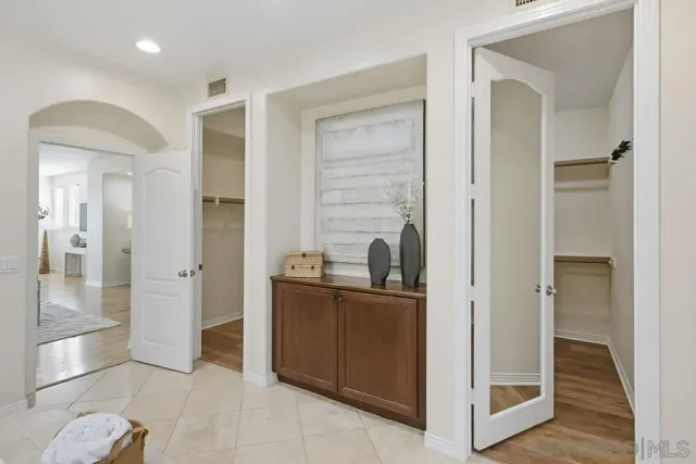 a bathroom with a granite countertop shower a sink and a mirror