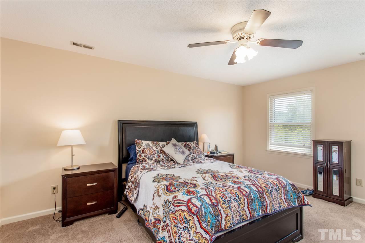 2300 Declaration Drive Raleigh, NC 27615 - Photo 12 of 30 a bedroom with a bed and a lamp