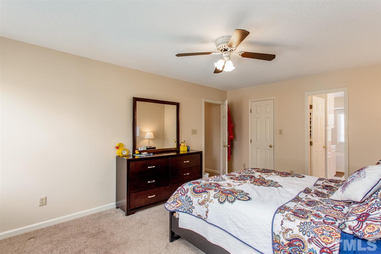 2300 Declaration Drive Raleigh, NC 27615 - Photo 13 of 30 a bedroom with a bed and a dresser
