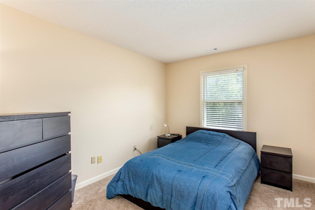 2300 Declaration Drive Raleigh, NC 27615 - Photo 16 of 30 a bedroom with a bed and cabinet