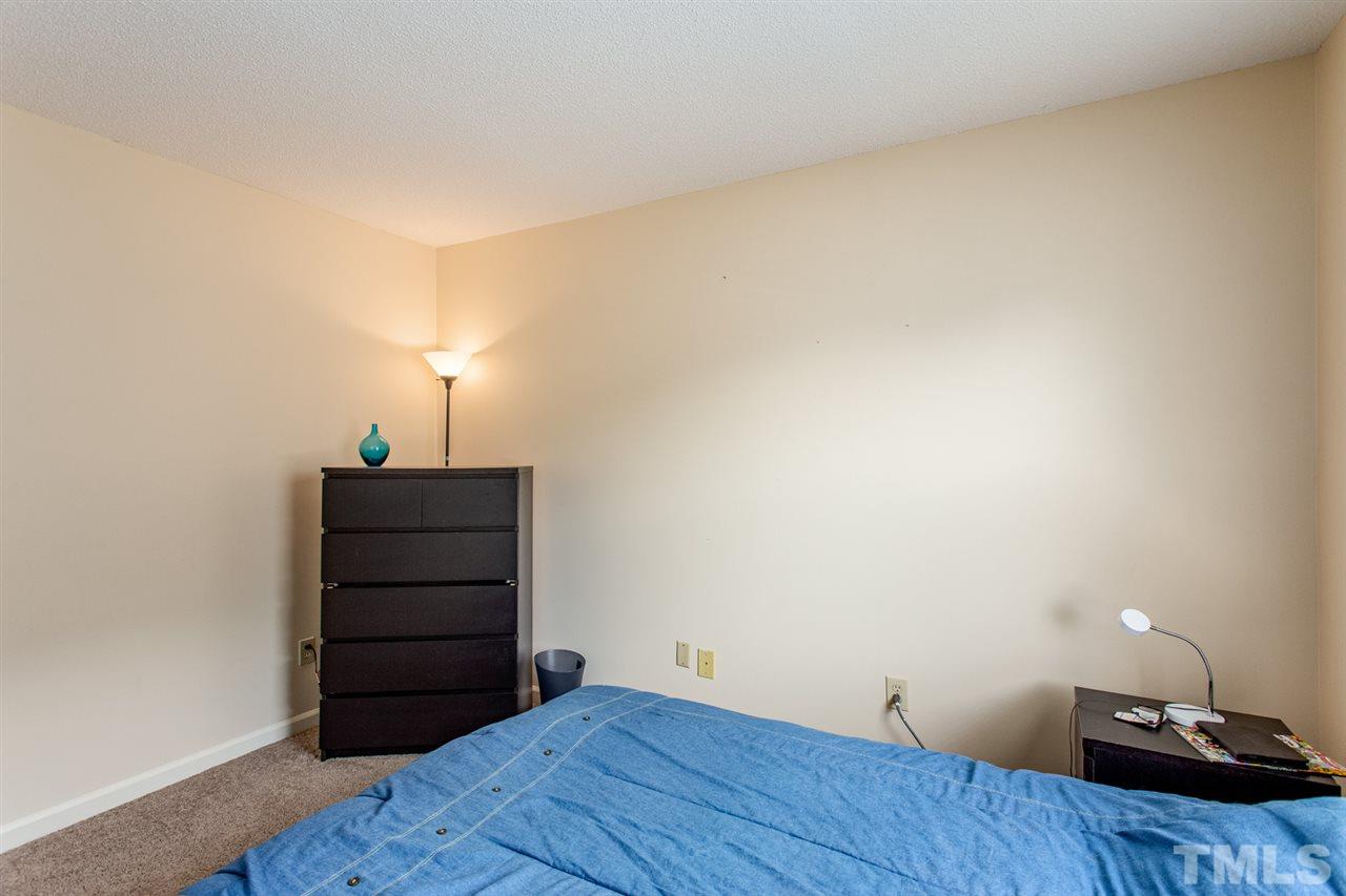 2300 Declaration Drive Raleigh, NC 27615 - Photo 17 of 30 a room with a bed and a lamp