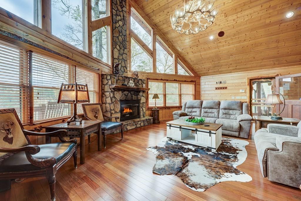 787 Choctaw Ridge Blue Ridge, GA 30513 - Photo 1 of 1 a living room with fireplace furniture and a large window