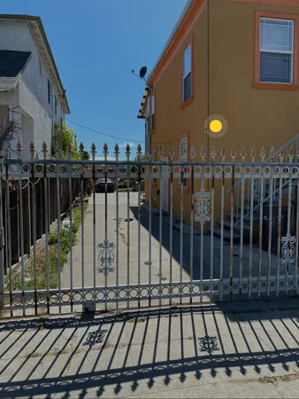a view of a street with wooden fence