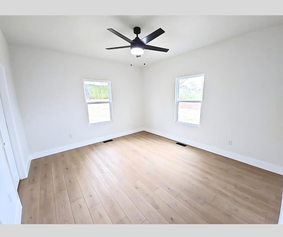432 Englewood Road Madisonville, TN 37354 - Photo 11 of 13 wooden floor in an empty room with a window