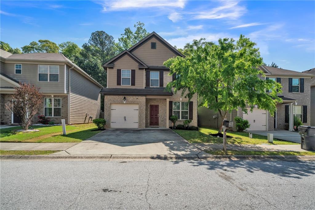 5828 Grande River Road Atlanta, GA 30349 - Photo 1 of 1 a front view of a house with a yard and garage