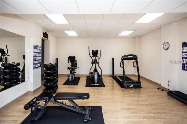 a room with gym equipment and windows