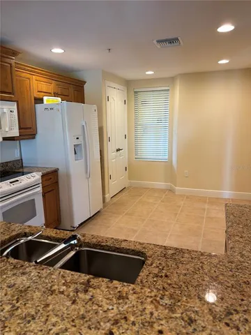 a room with a refrigerator and a window