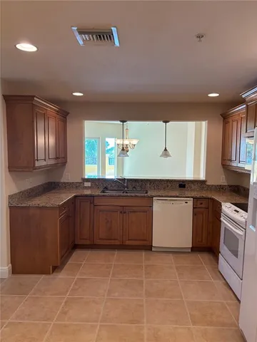 a kitchen with a sink a counter top space and appliances