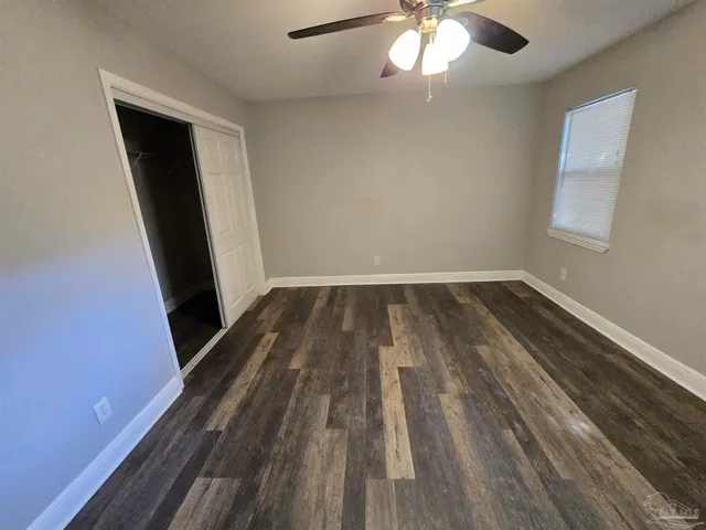wooden floor in an empty room with a mirror
