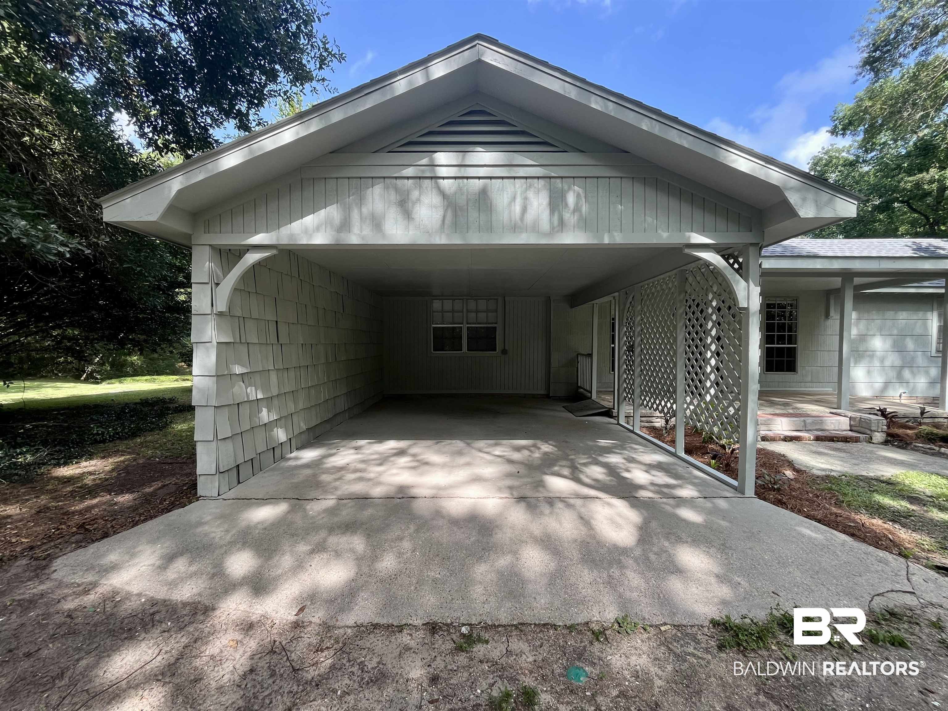 3105 Bryant Road Mobile, AL 36605 - Photo 3 of 39 Carport entrance featuring shingle siding and decorative lattice