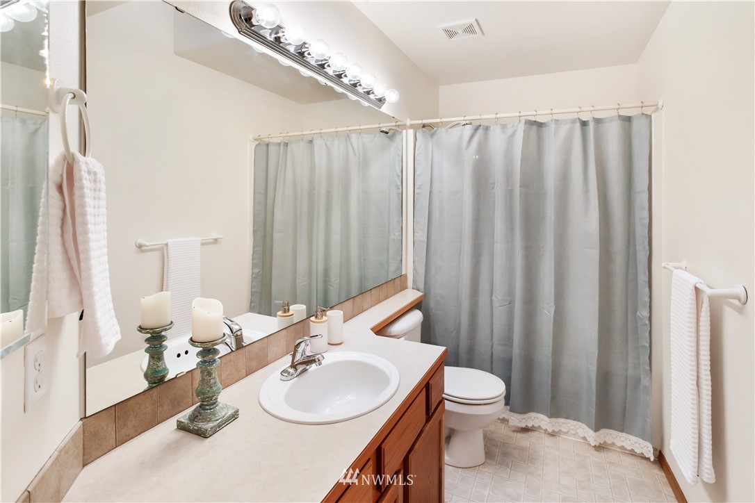 27 167th Place Southwest Bothell, WA 98012 - Photo 11 of 25 a bathroom with a sink a toilet and shower curtain