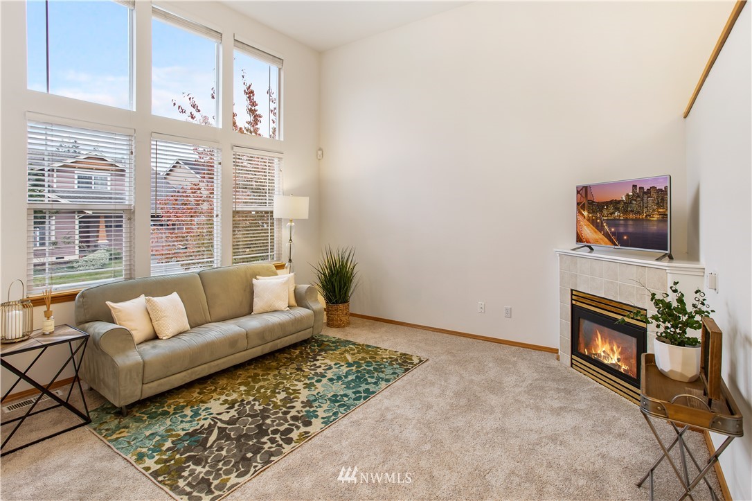 27 167th Place Southwest Bothell, WA 98012 - Photo 3 of 25 a living room with furniture a flat screen tv and a large window