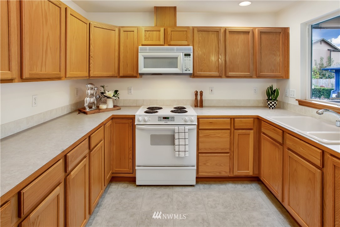 27 167th Place Southwest Bothell, WA 98012 - Photo 6 of 25 a kitchen with stainless steel appliances granite countertop a sink a stove and cabinets