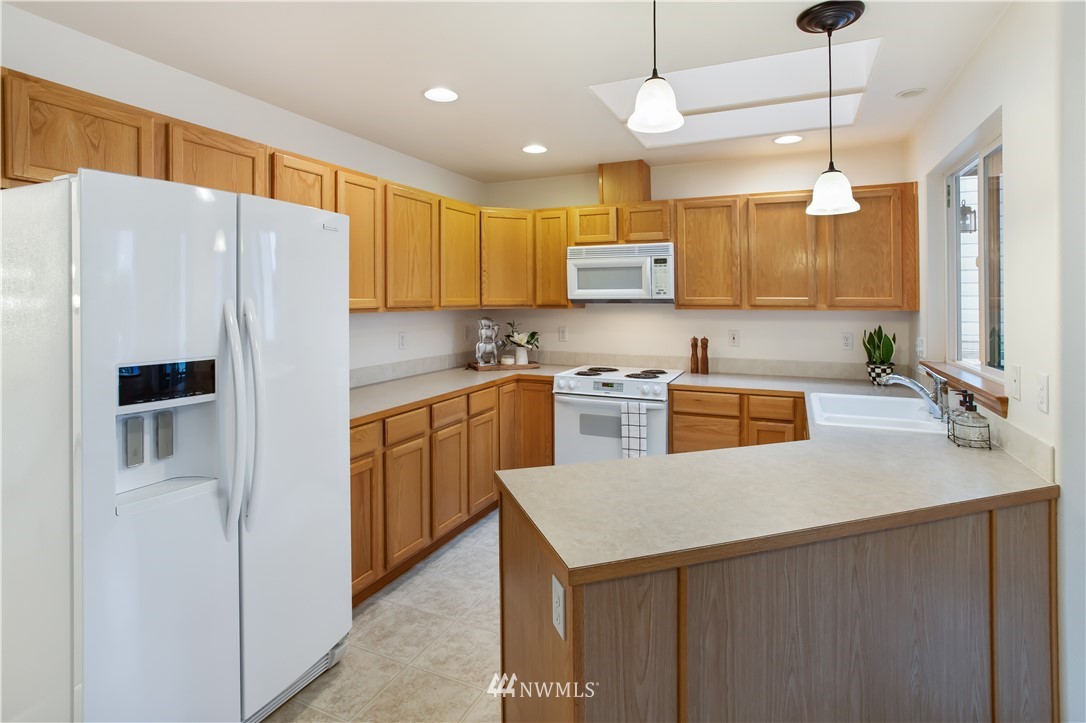 27 167th Place Southwest Bothell, WA 98012 - Photo 7 of 25 a kitchen with stainless steel appliances a refrigerator sink and microwave