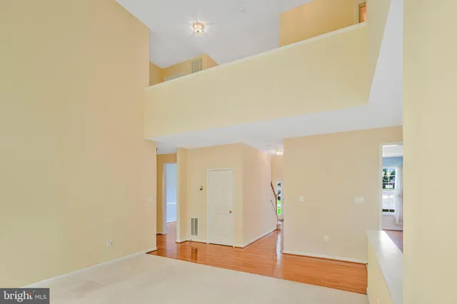 a view of a room with wooden floor and cabinet