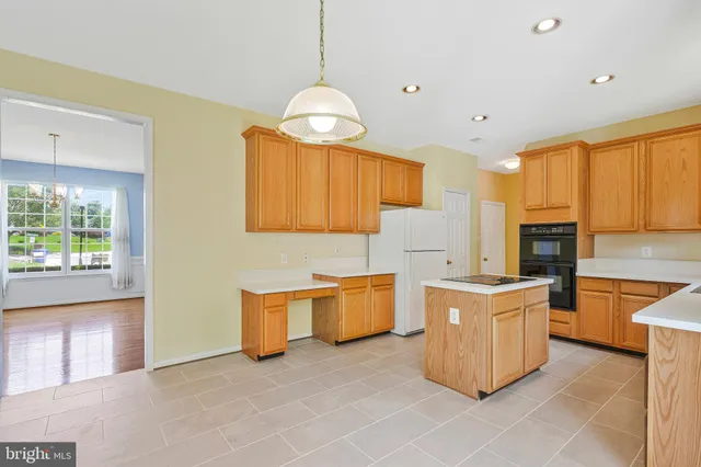 a kitchen with a stove a sink and a refrigerator