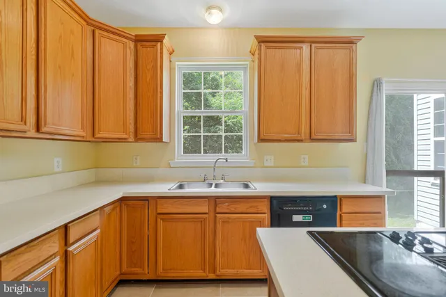 a kitchen with a sink cabinets and window