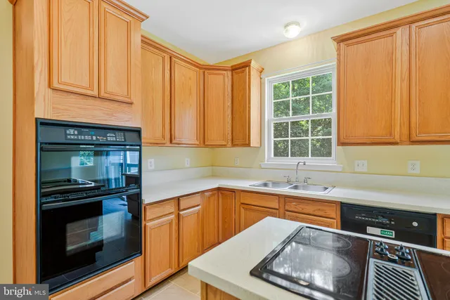 a kitchen with stainless steel appliances granite countertop a stove and a sink