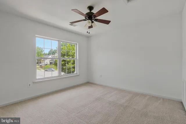 a view of a room with a ceiling fan