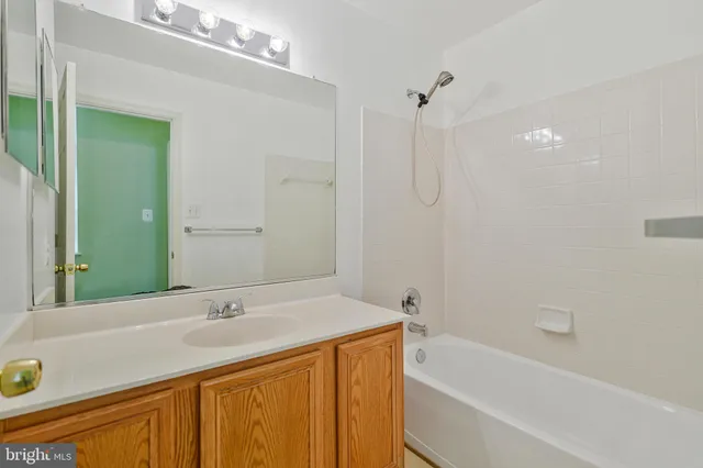 a view of a room with a ceiling fan and a window