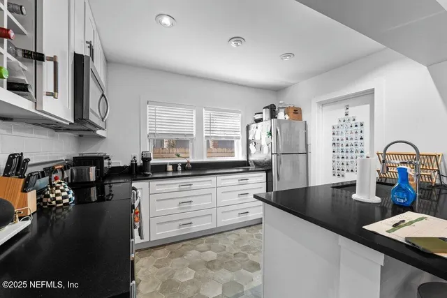 a kitchen with refrigerator and stove