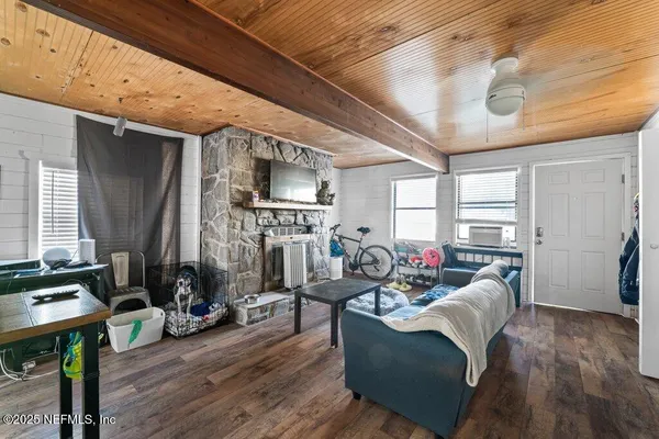a view of a livingroom with furniture a ceiling fan and a window