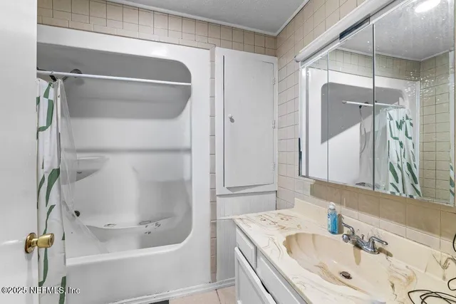 a bedroom with a bed a dresser and a window